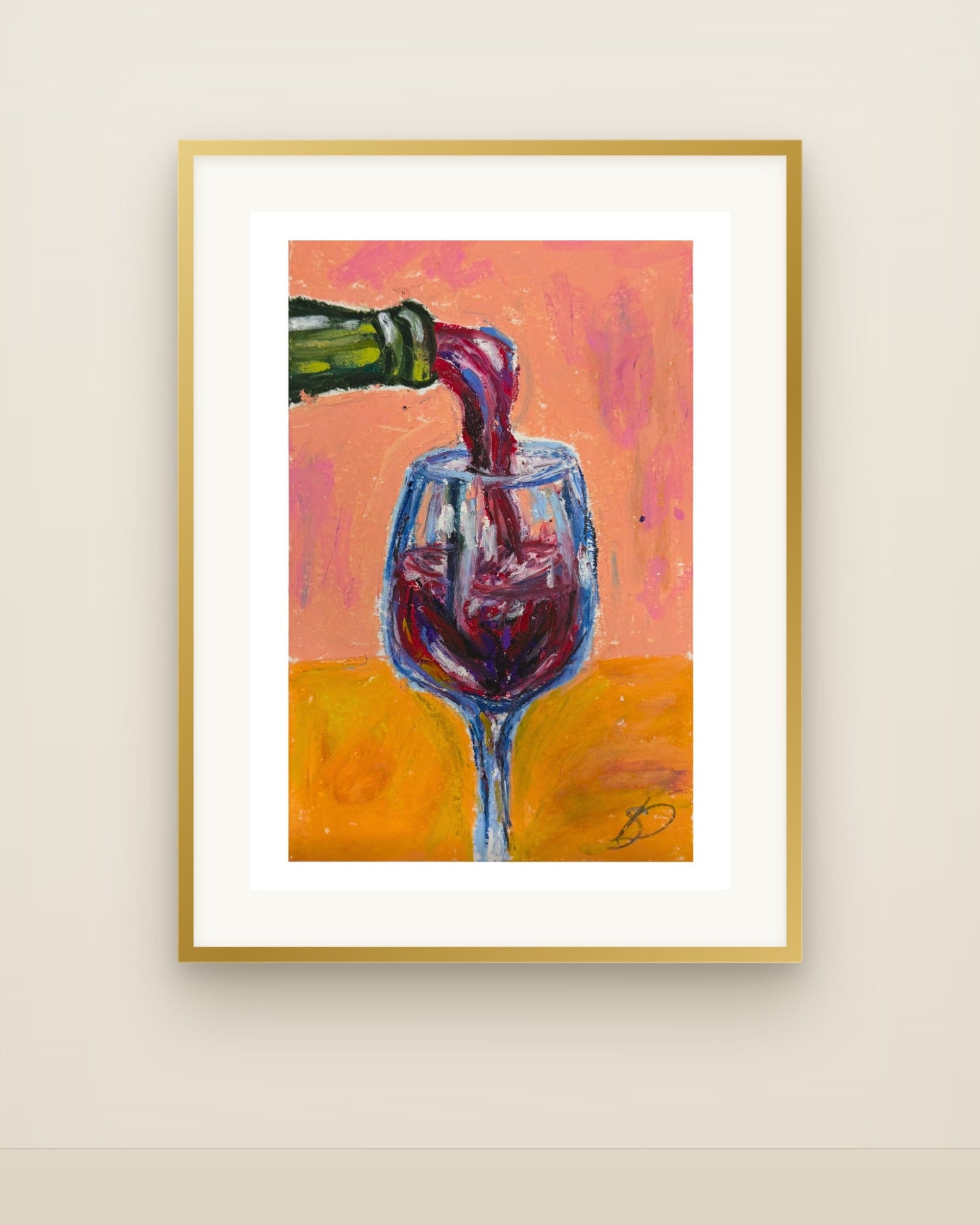 A framed art print depicting red wine being poured from a green bottle into a glass, set against a warm orange and pink background. The print is housed in a white mat and a thin gold frame, hanging on a light beige wall.